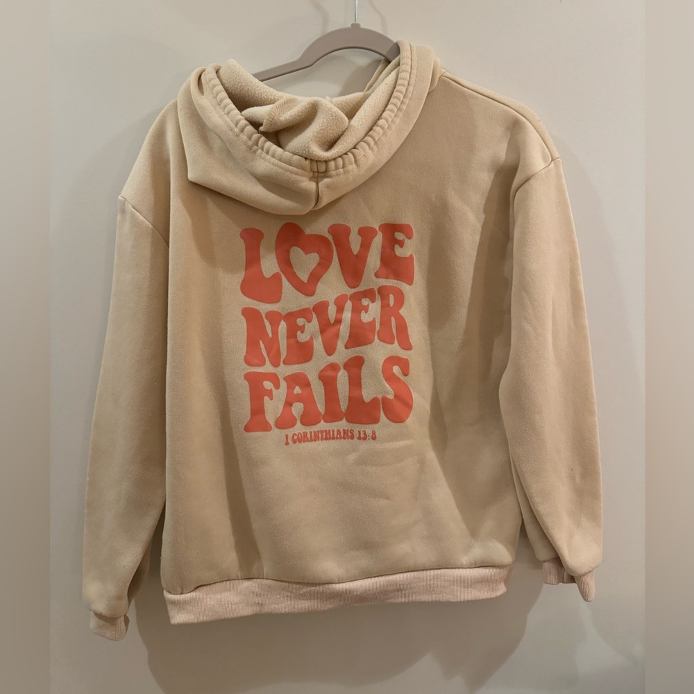 Shein Tan and Pink Love Never Fails Bible Verse Sweatshirt